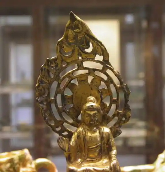 Solar disc behind a buddha figurine